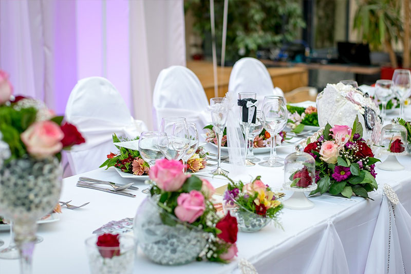 wedding table with flowers and chairs